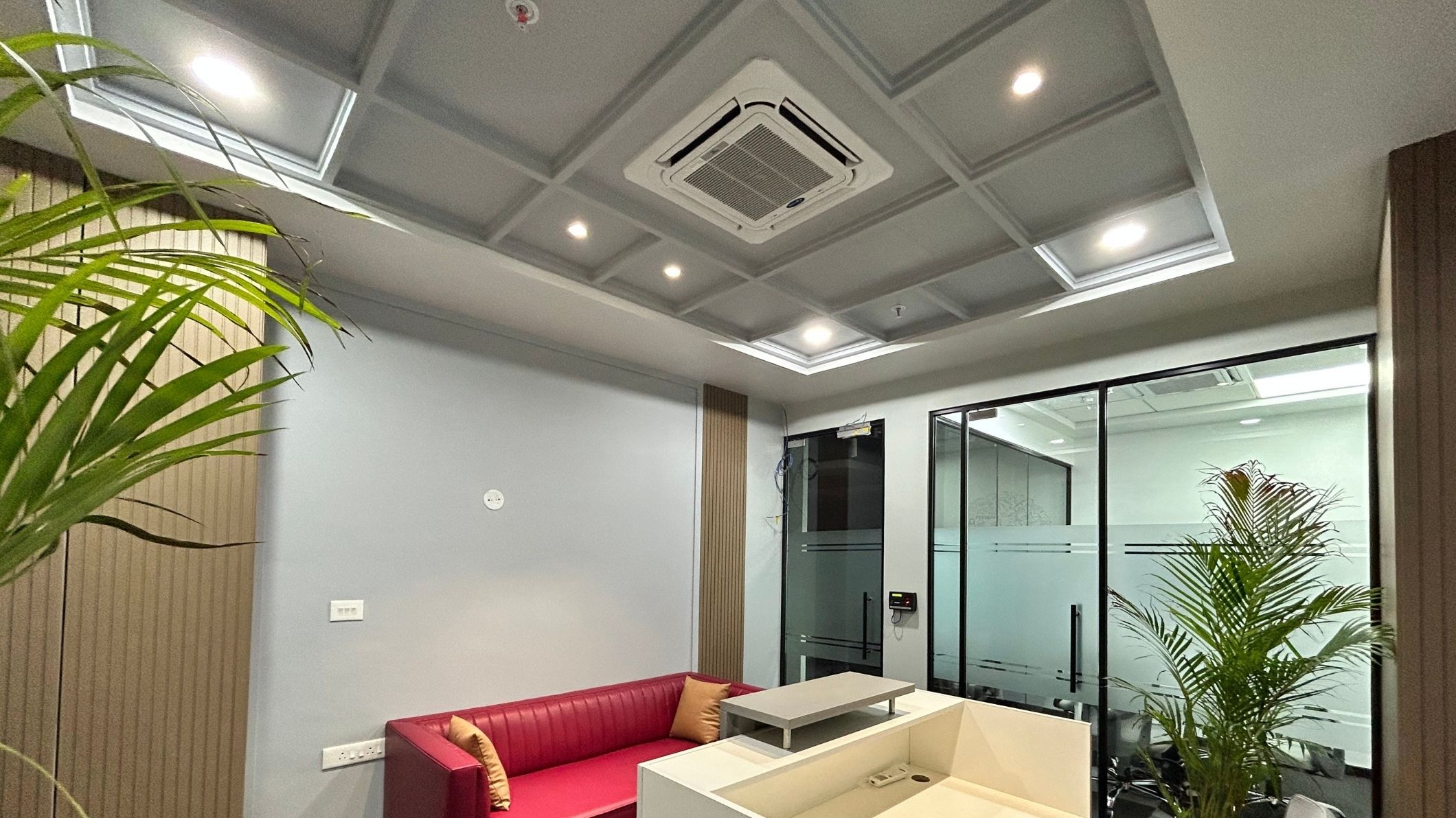 Ceiling cassette air conditioner installed in an office lobby, providing even cooling and maintaining a comfortable temperature for visitors.